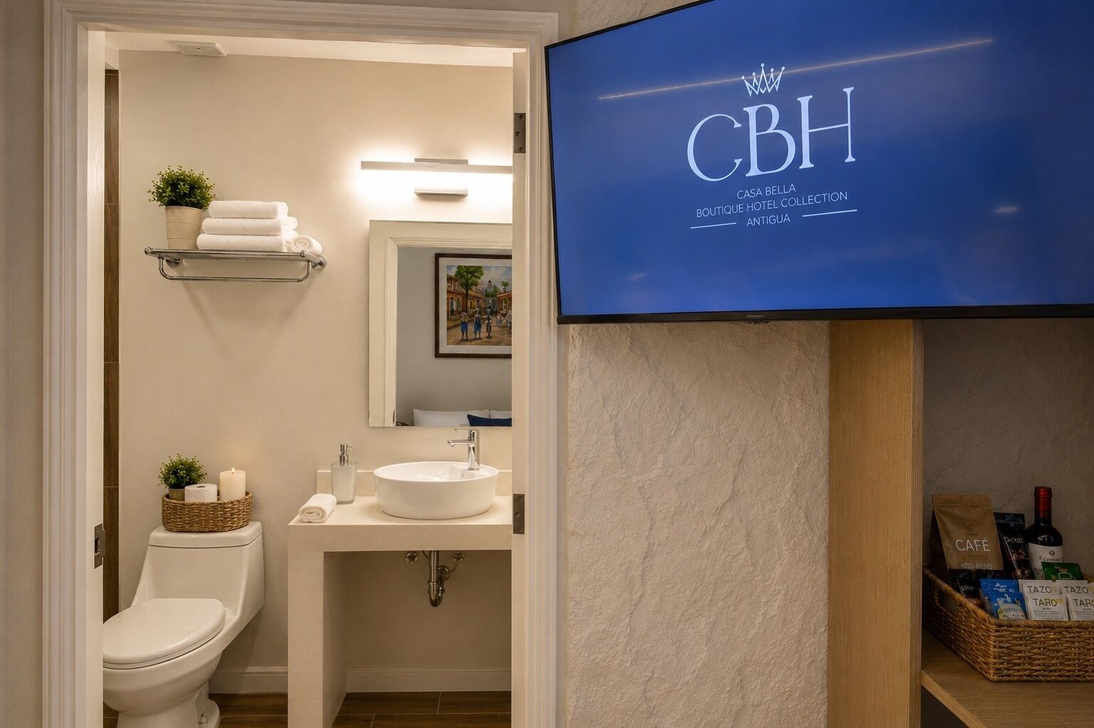 Kylpyhuone, jossa on wc, pesuallas ja televisio, jolla näkyy «Casa Bella Boutique Hotel Collection Antigua» -ohjelma.