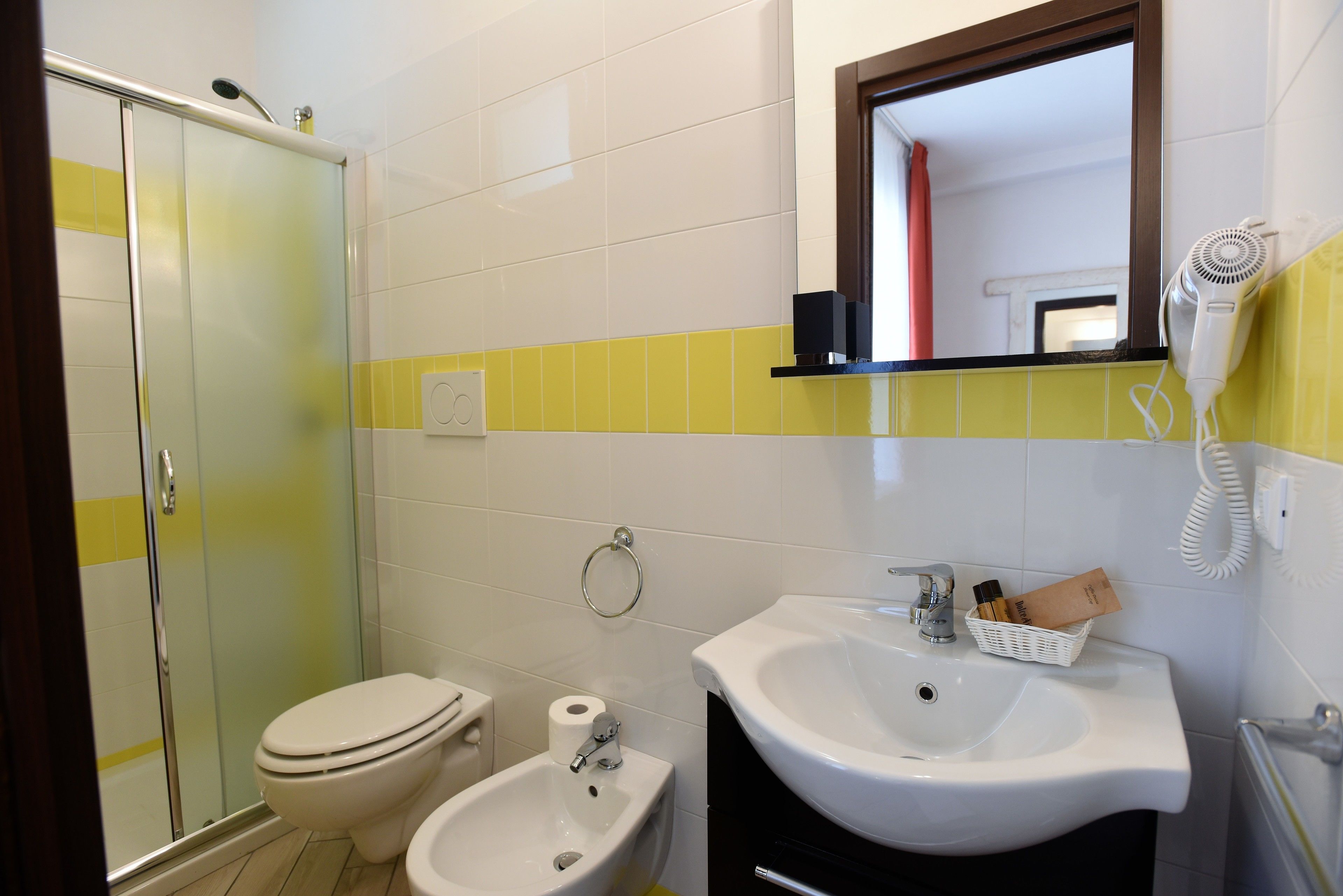 Un baño con inodoro, bidé y lavamanos.