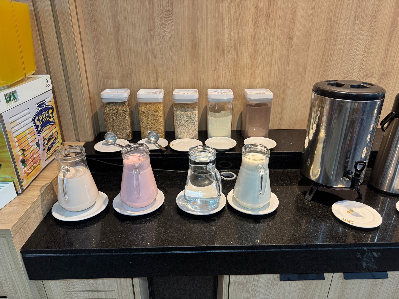A kitchen counter with various containers and a coffee maker.
