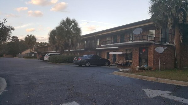 A two-story motel with a parking lot.