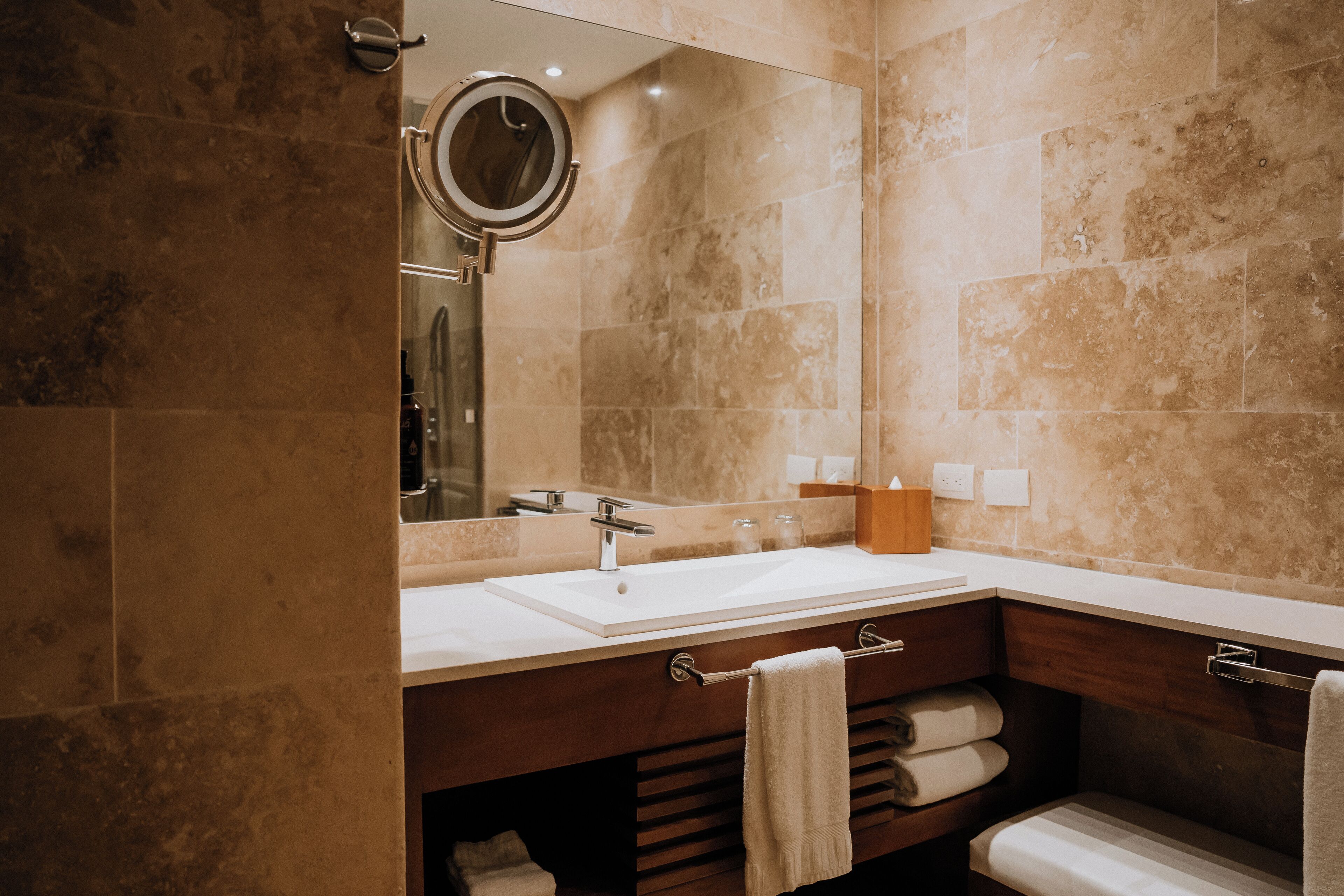 A bathroom with two sinks, a mirror, and a towel rack.