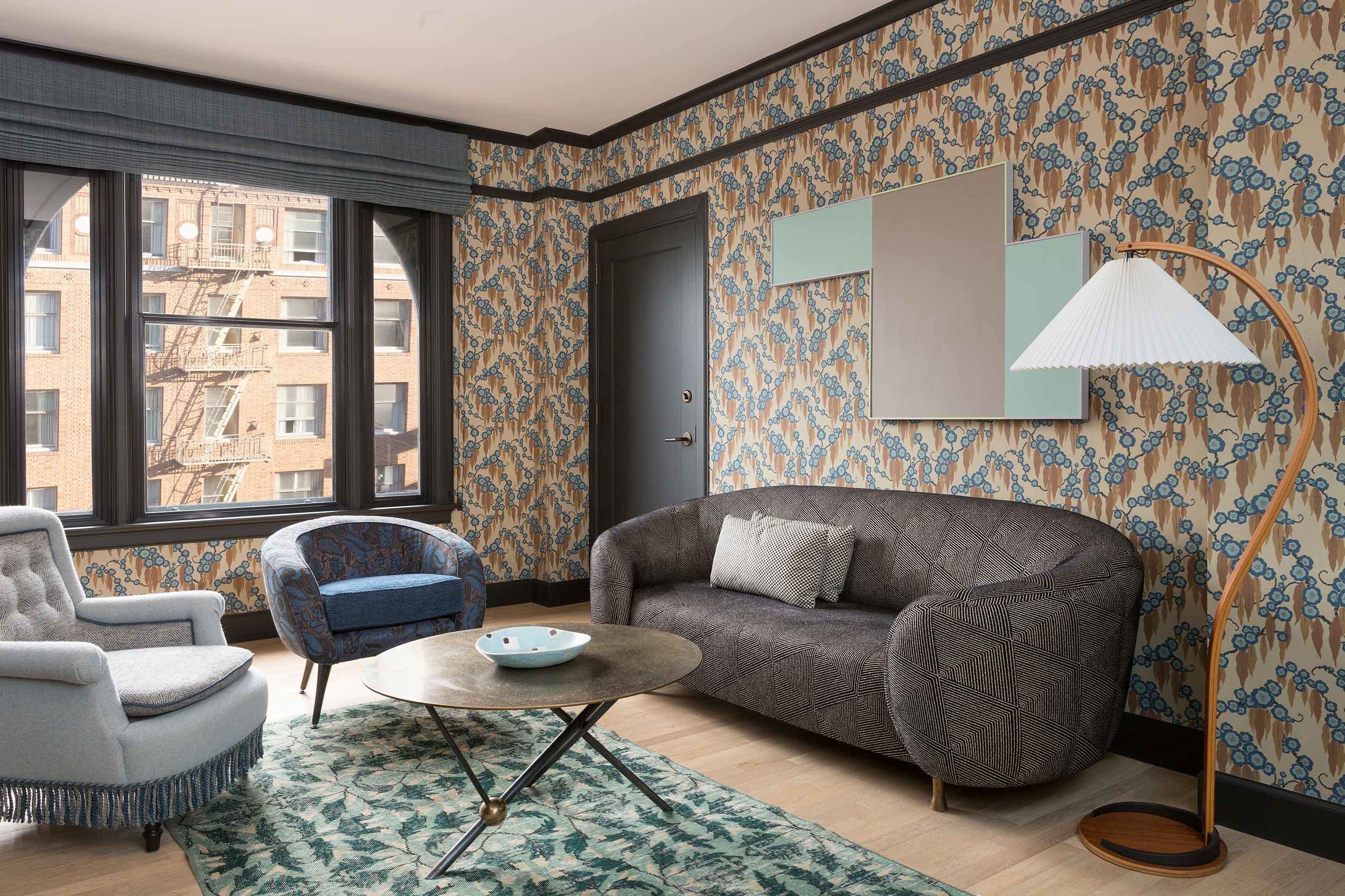 Un salon moderne avec un canapé, un fauteuil et une table basse ronde.
