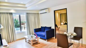 Deluxe Apartment | Living room | 32-inch LCD TV with digital channels, TV, DVD player