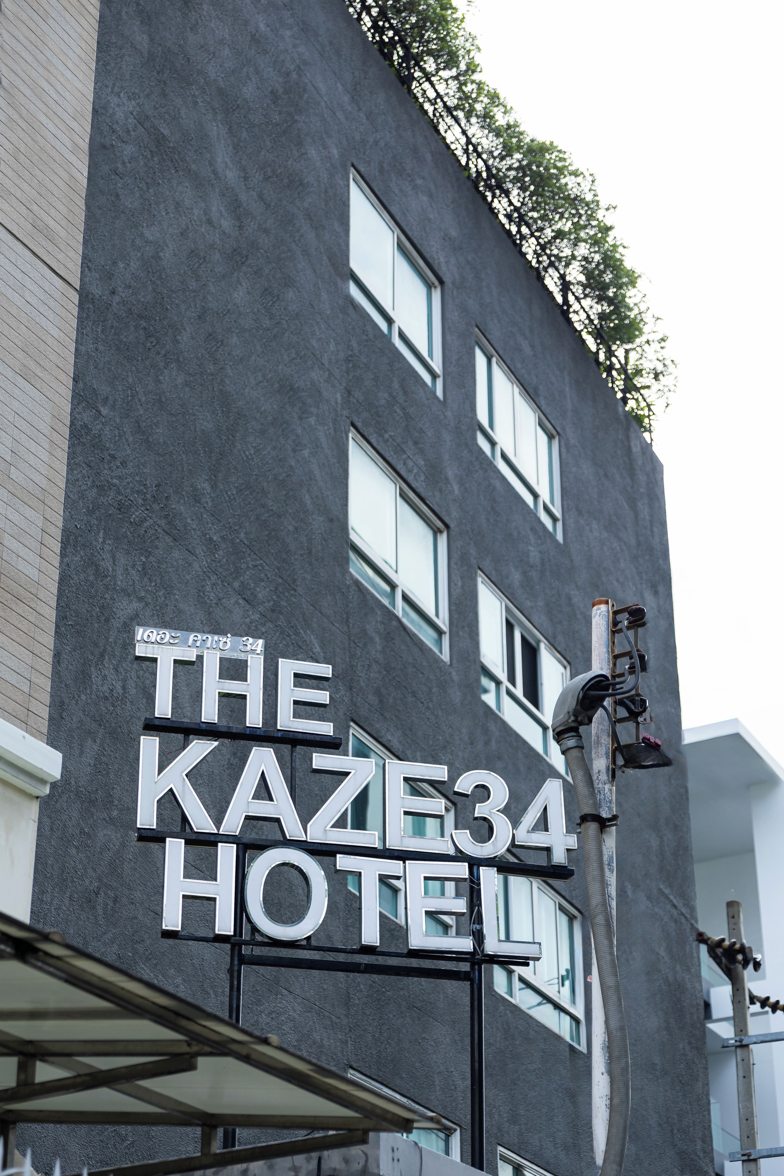 A building with a sign that reads 'The Kaze34 Hotel' indicating the name of the establishment.