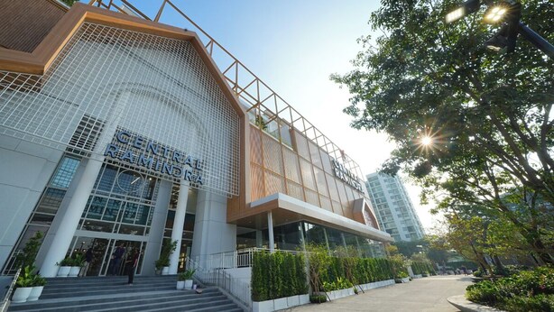 A modern building with a prominent entrance, large glass windows, and a metal facade. - Leelawadee Resotel Raminthra 23 (Bangkok)