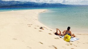 A beach with a clear view of mountains in the background. - Pandan Beach Resort (Pandan)