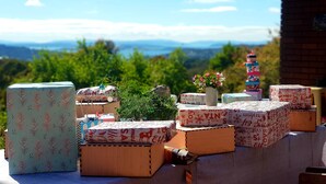 A collection of wooden boxes with Christmas-themed wrapping paper, arranged outdoors with a scenic view in the background. - The Hobart Entrance (Kingston)