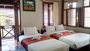 A hotel room with two beds, a balcony, and a painting on the wall. - Sokmisay Hotel・GuestHouse (Luang Prabang)