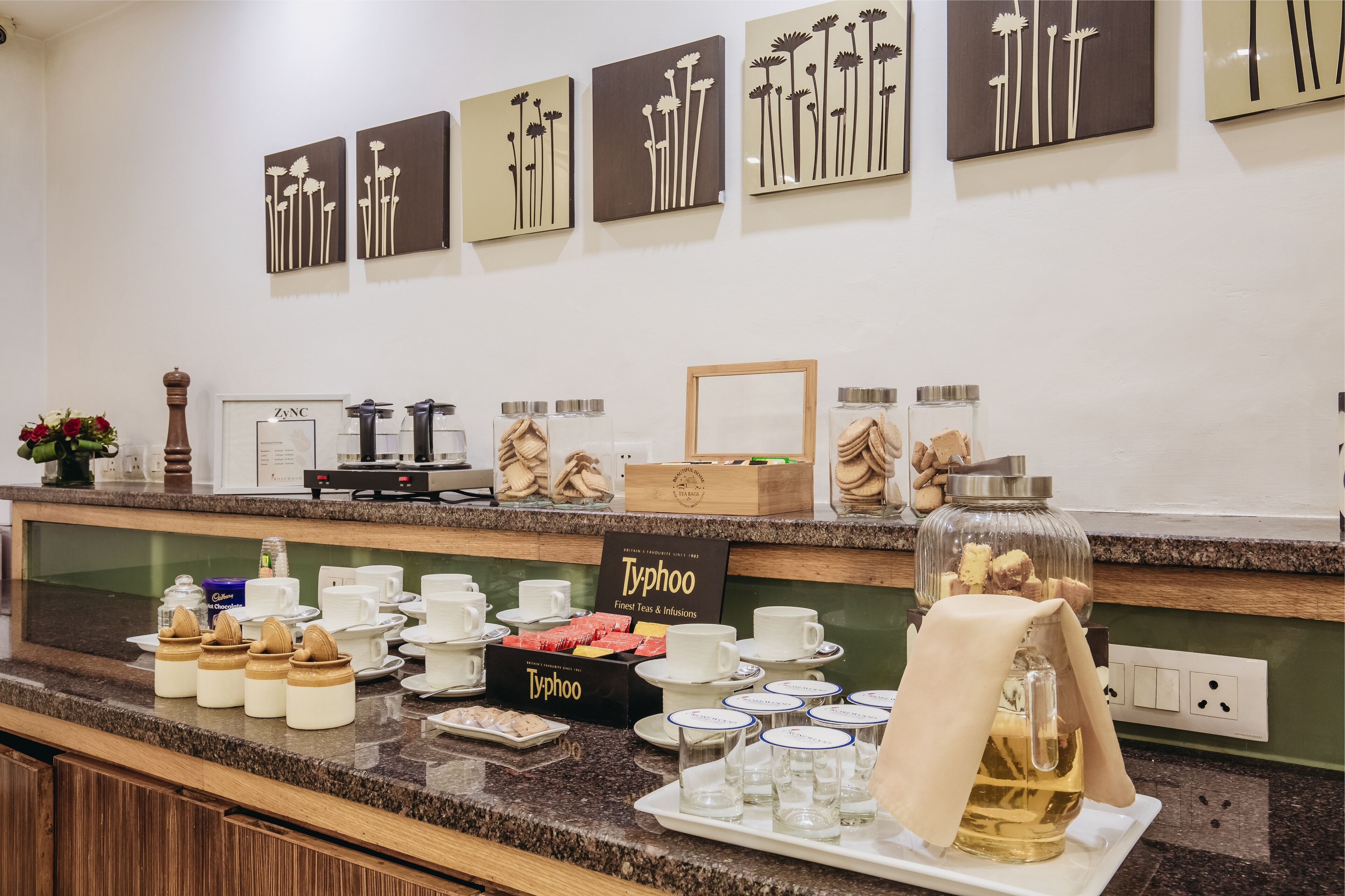 A breakfast buffet with various food items, coffee, and tea options.