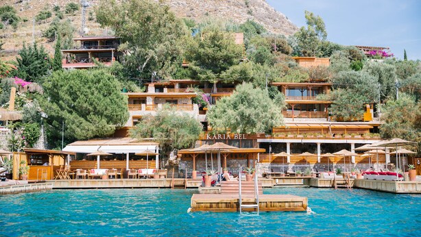 A coastal hotel with multiple balconies, outdoor seating, and a pool area. - Karia Bel Hotel & Restaurant - Adults Only (Marmaris)