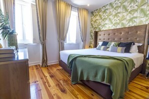 A bedroom with a large bed, a wooden dresser, and a window with curtains. - Your Home In Bairro Alto Lisbon (Lisbon)