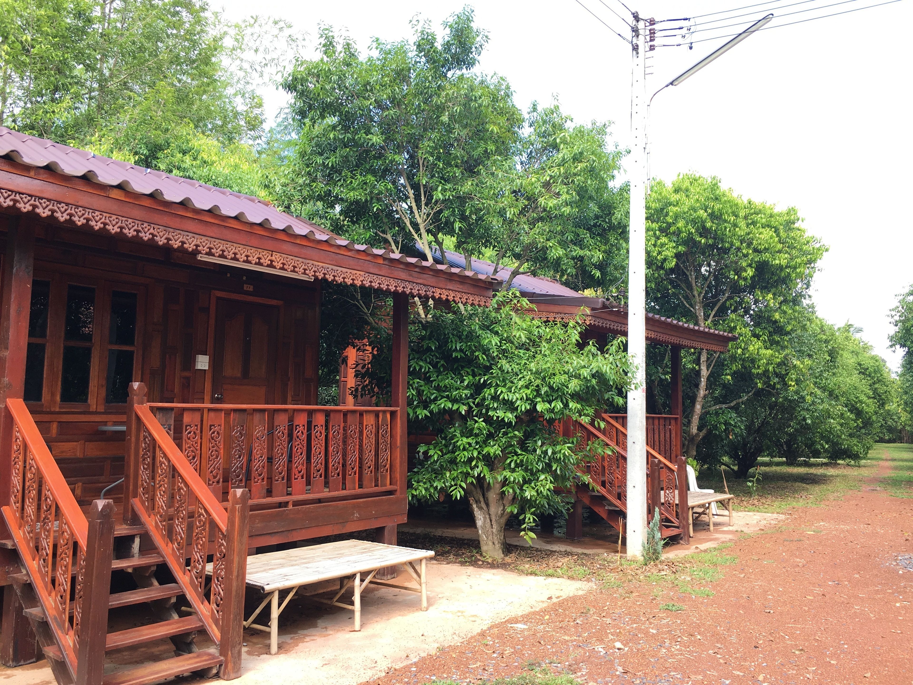 A traditional wooden building with a porch and staircase.
