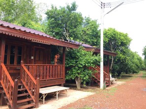 A traditional wooden building with a porch and staircase. - Ban Suan Kru Kob (Pak Phli)