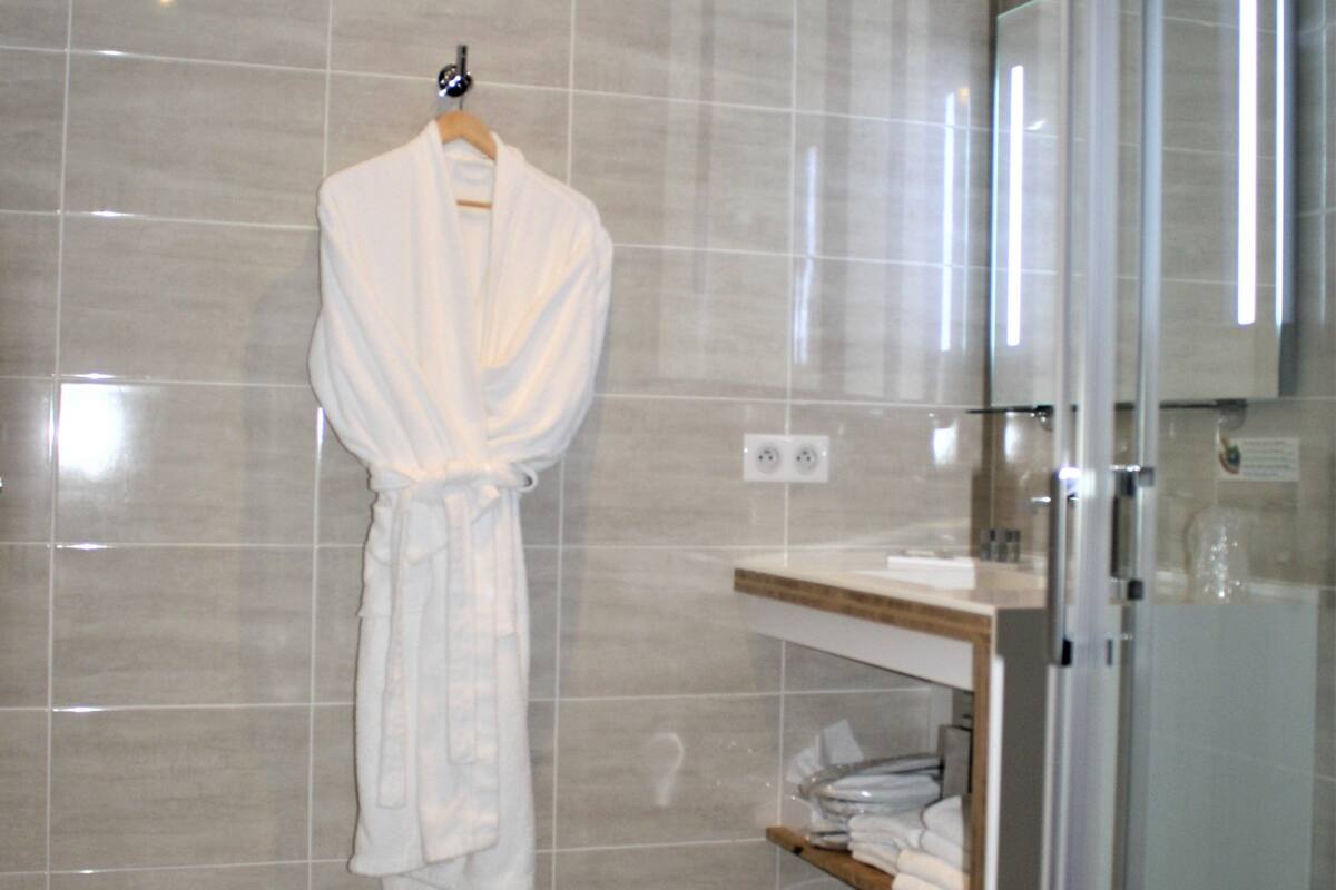 junior suite, 1 queen bed with sofa bed | bathroom | shower, free toiletries, hair dryer, towels