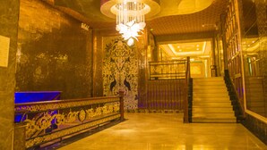 A grand staircase with ornate railings and a chandelier. - Grand Szechuan Hotel Vientiane (Vientiane)