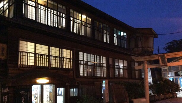 A traditional Japanese building with multiple windows and a signboard. - Horieya Ryokan (Fukushima)