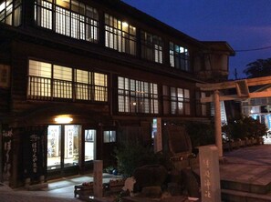 A traditional Japanese building with multiple windows and a signboard. - Horieya Ryokan (Fukushima)