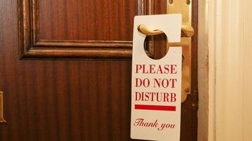 A door with a sign that reads "PLEASE DO NOT DISTURB Thank you".