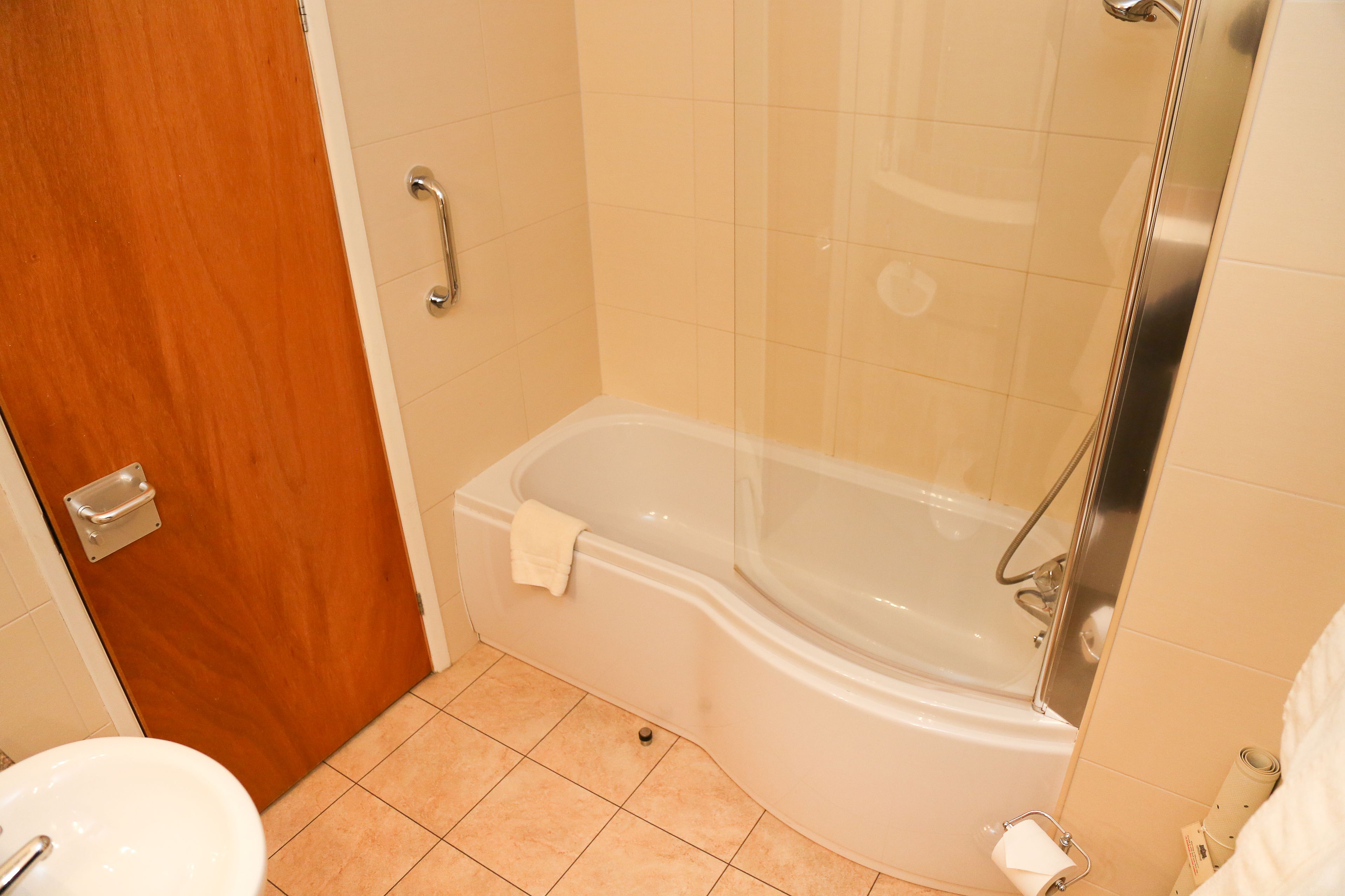 A bathroom with a bathtub, a toilet, and a sink.