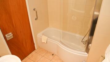 A bathroom with a bathtub, a toilet, and a sink.