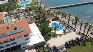 A resort with multiple swimming pools, a beach, and a pier. - Hotel Mare Datca (Datça)