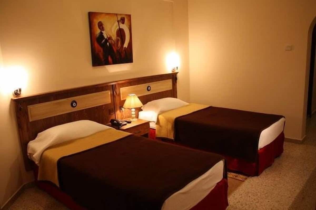 Standard Twin Room | Minibar, in-room safe, desk, iron/ironing board (on request)