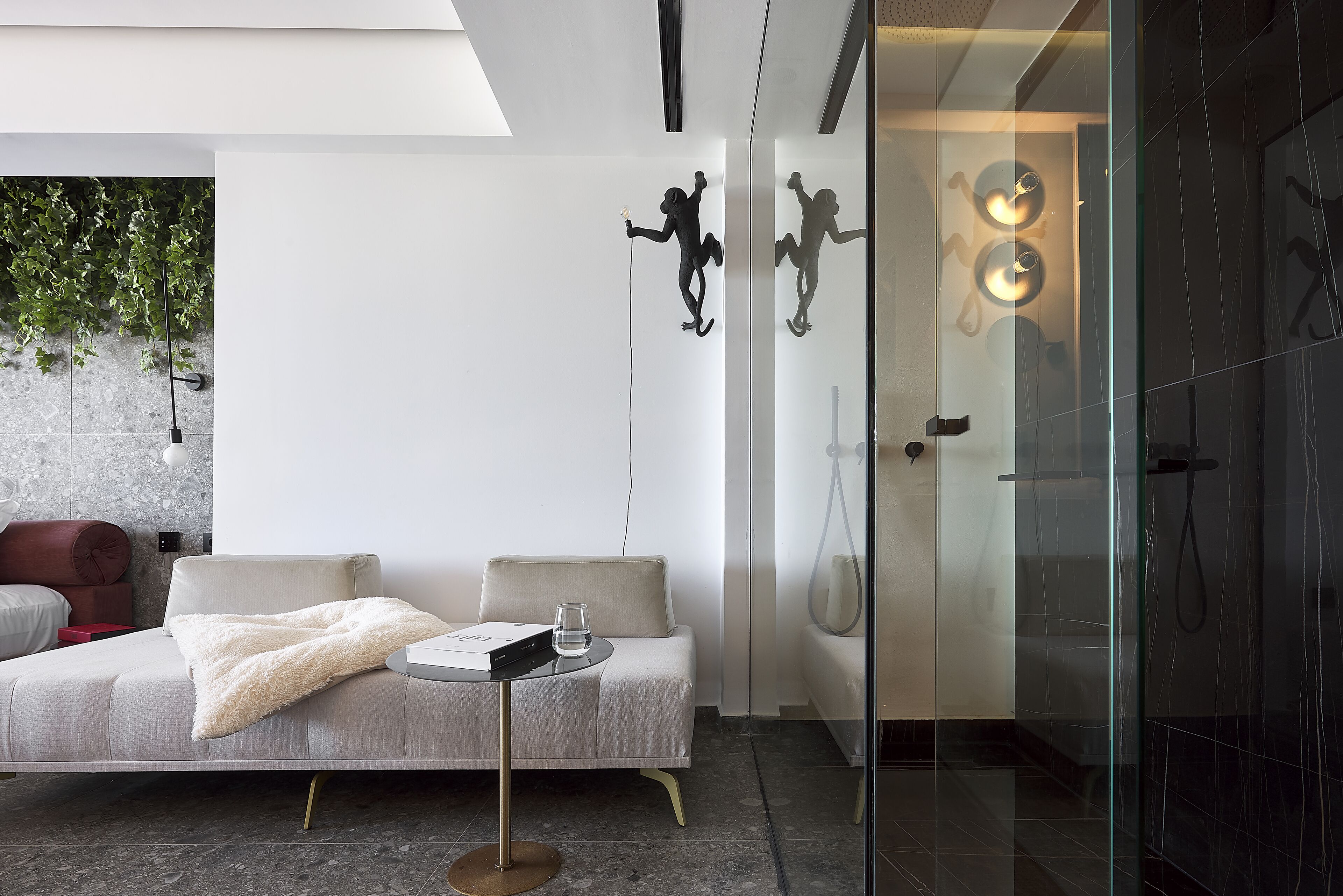 A modern bathroom with a glass shower enclosure, a white bathtub, and a glass door.