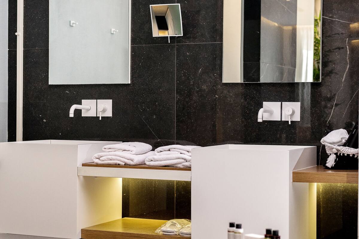 separate bathtub and shower, rainfall showerhead, designer toiletries