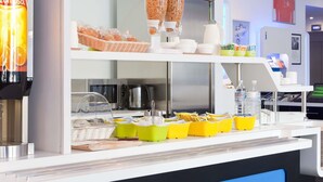 A breakfast bar with cereal, coffee, and water dispensers.