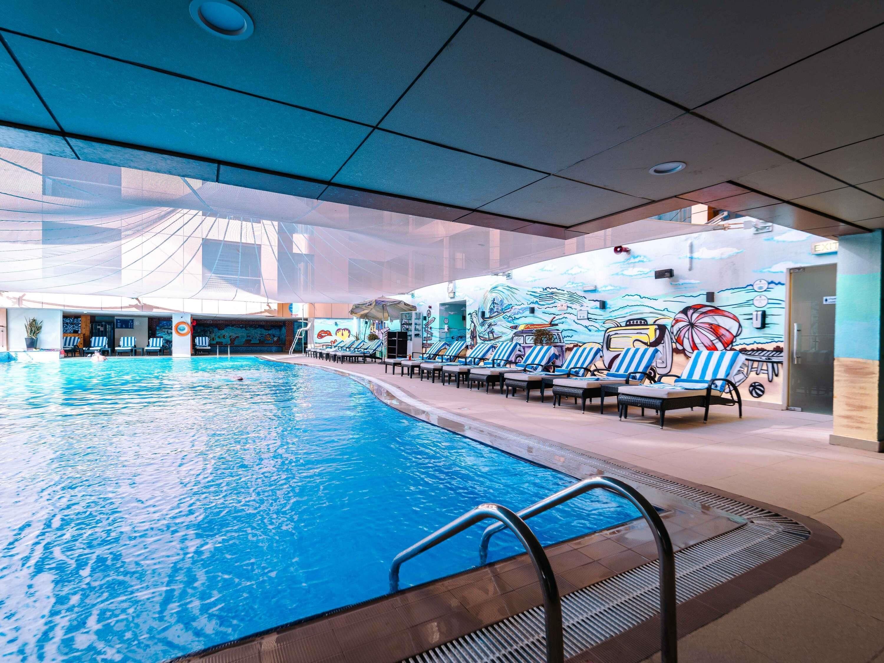 Outdoor pool, open 7:00 AM to 7:00 PM, pool loungers, lifeguards on site