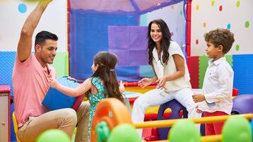 Children can play safely on padded surfaces and colorful play structures.