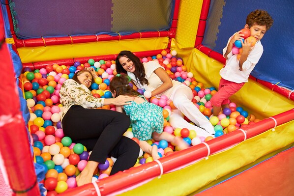 A colorful inflatable play area with a ball pit.
