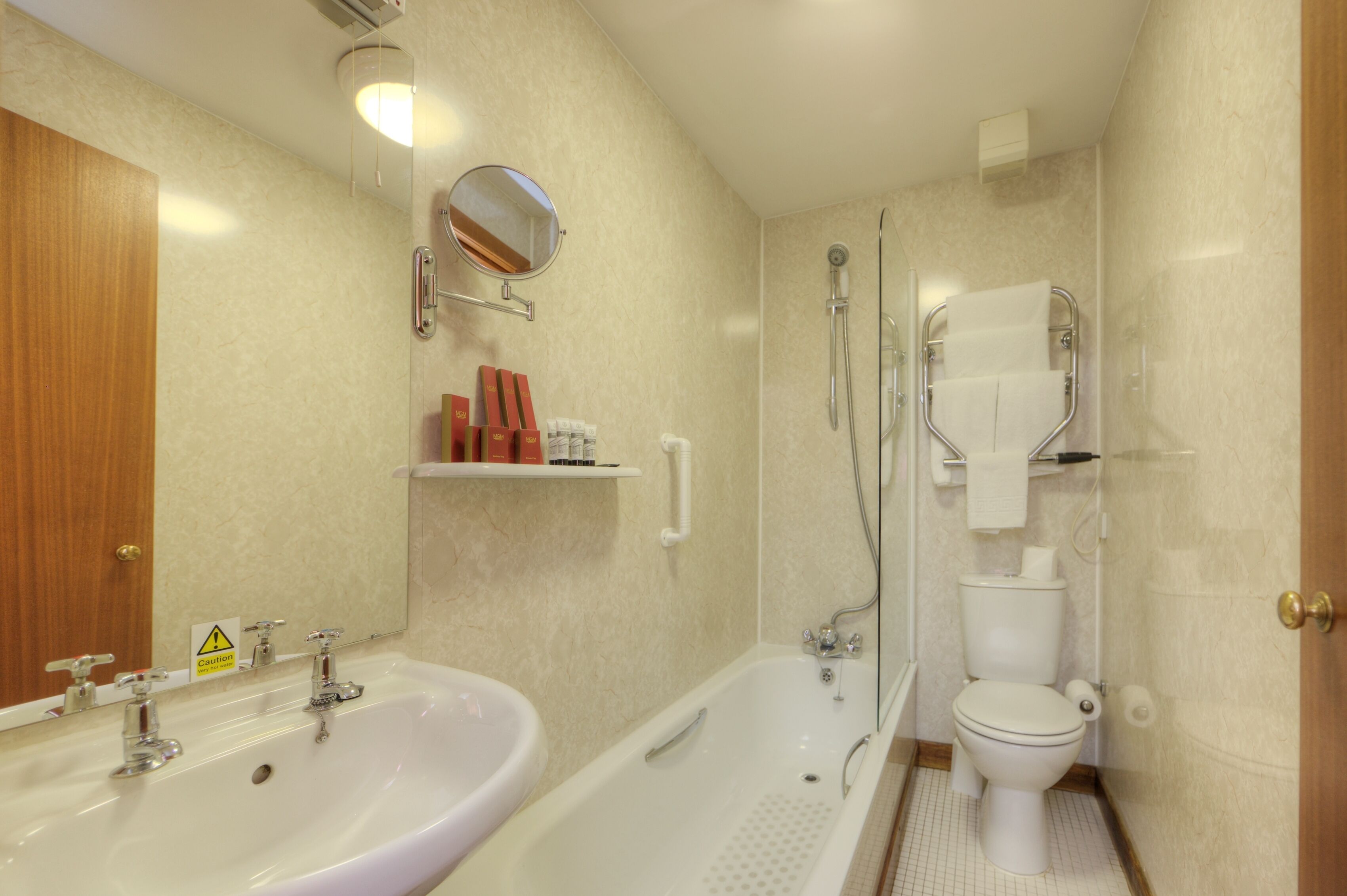 A bathroom with a sink, bathtub, toilet, and a shower.