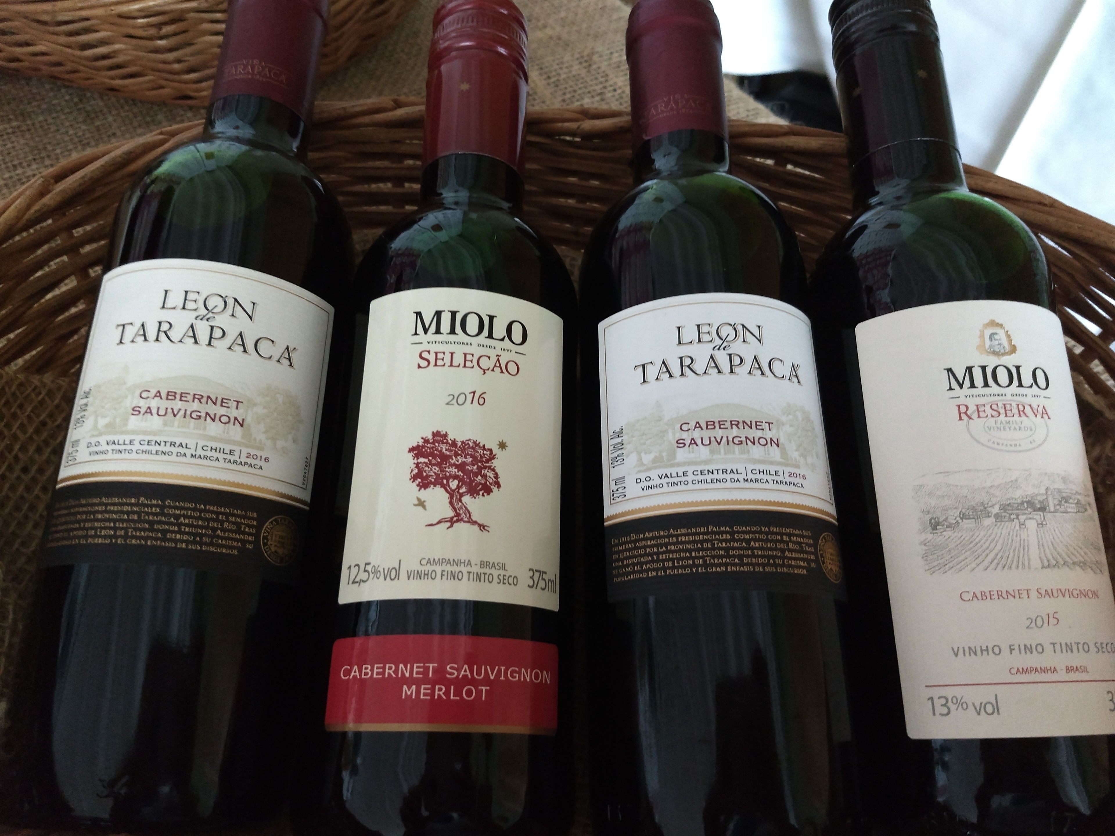 Four bottles of wine, each with a label indicating they are Cabernet Sauvignon from Leon de Tarapaca.