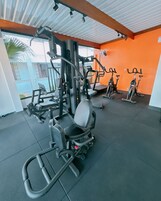 A gym with various exercise equipment, including a squat rack and treadmills.