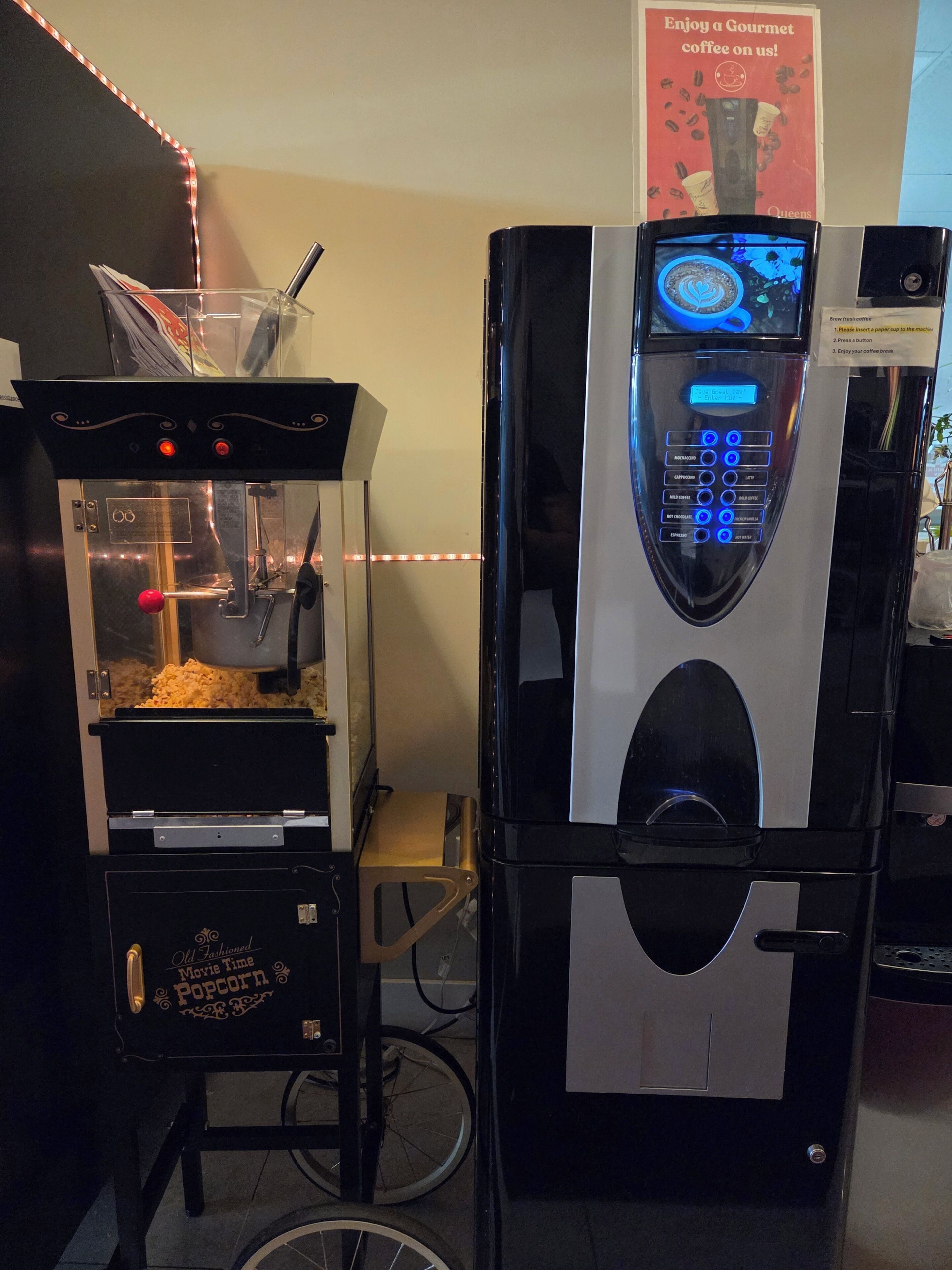 A popcorn machine and a coffee machine in a commercial setting.
