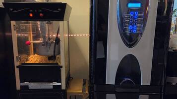 A popcorn machine and a coffee machine in a commercial setting.
