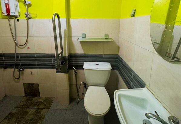 A bathroom with a toilet, sink, and shower.