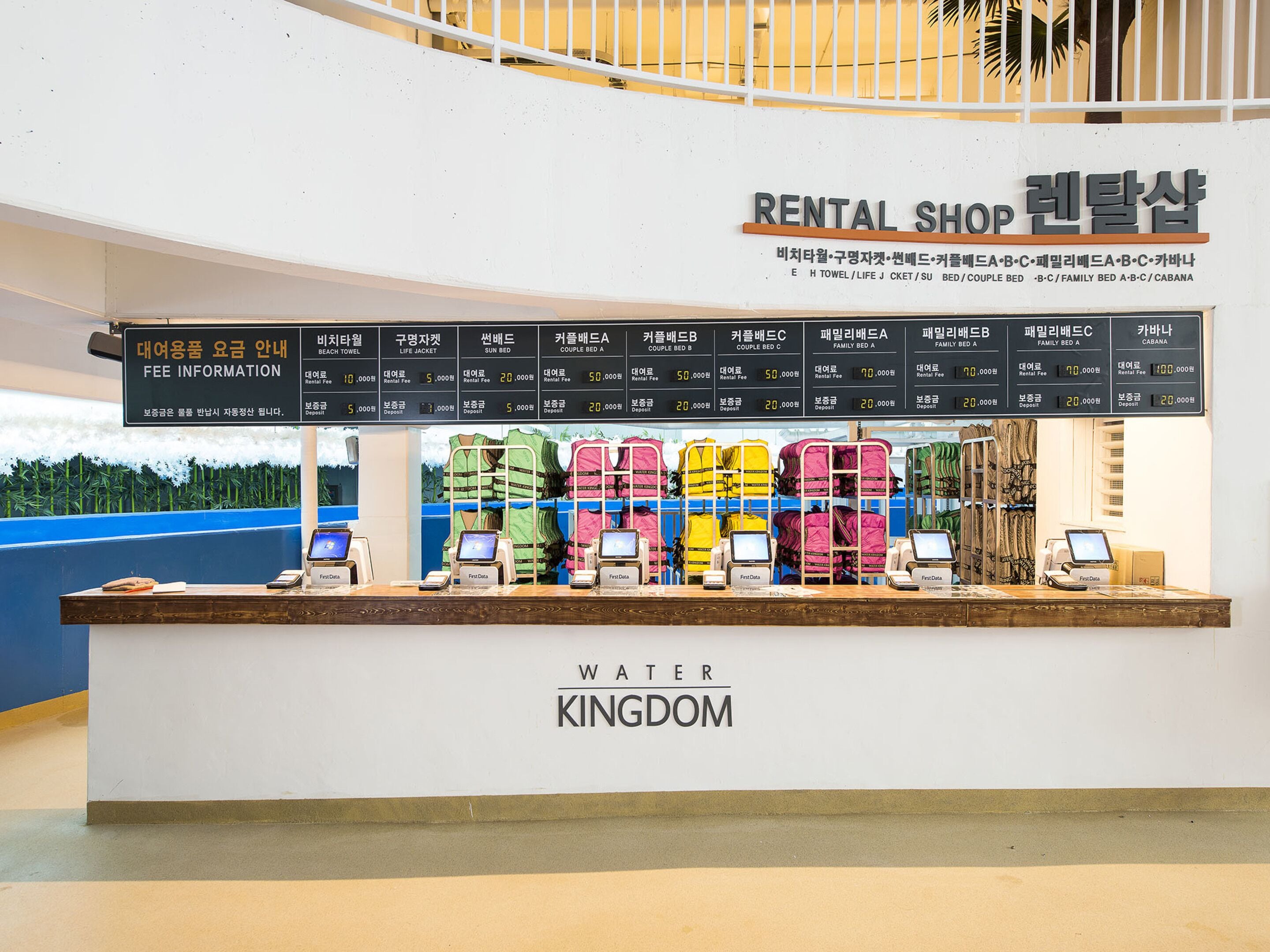 A rental shop with a signboard listing various types of beds and their prices.