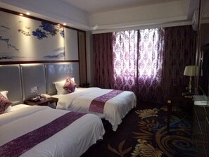 A hotel room with two beds, a large window with curtains, a wall mural, and a carpet with a floral pattern. - Dengxillai Hotel Foshan (Foshan)