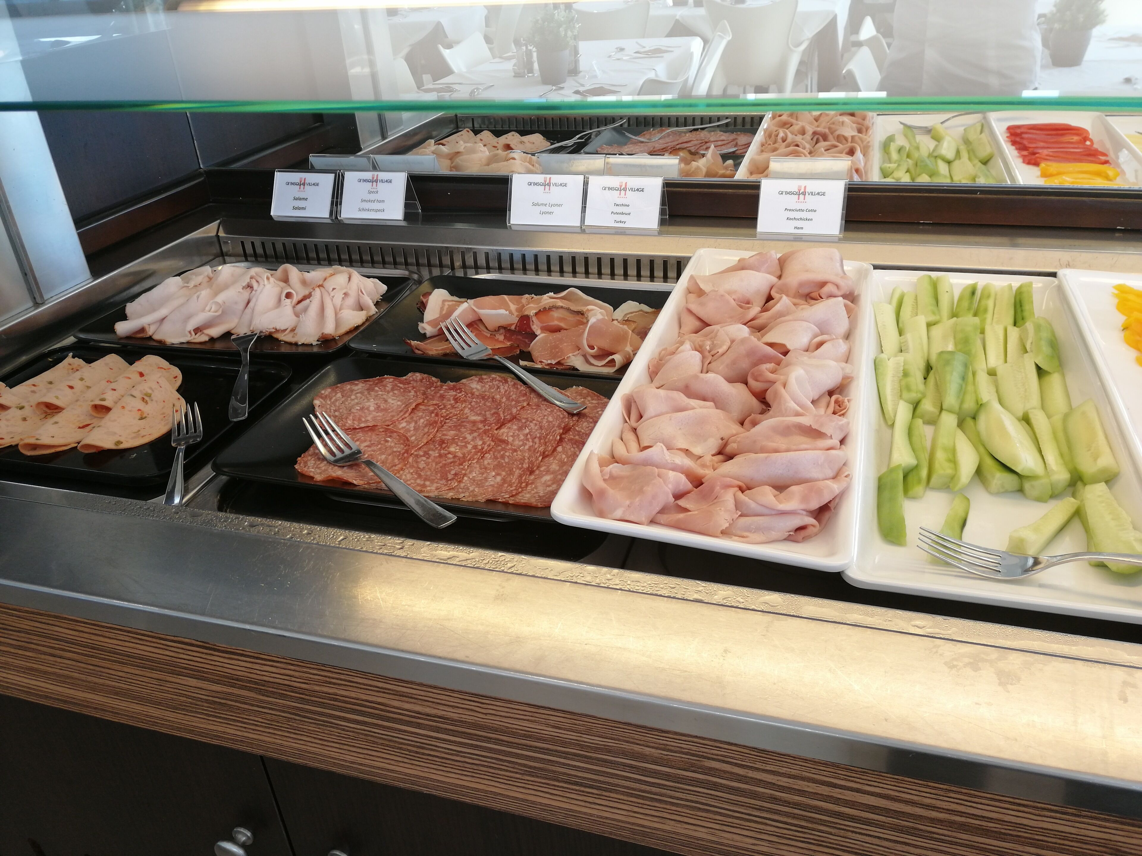 A buffet with various meats and vegetables.