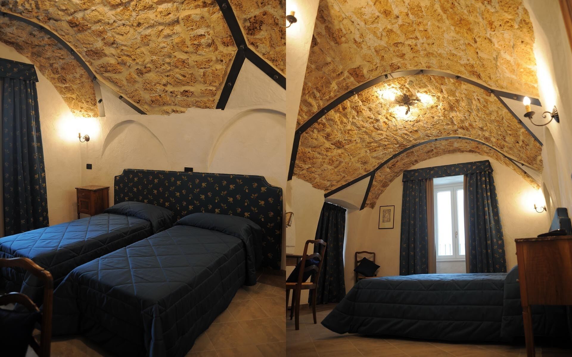 A room with two beds, a wooden chair, a desk, and a window with curtains.