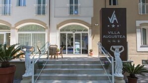 A building with a sign reading "VILLA AUGUSTEA" and a staircase leading to the entrance. - Villa Augustea (Rimini)
