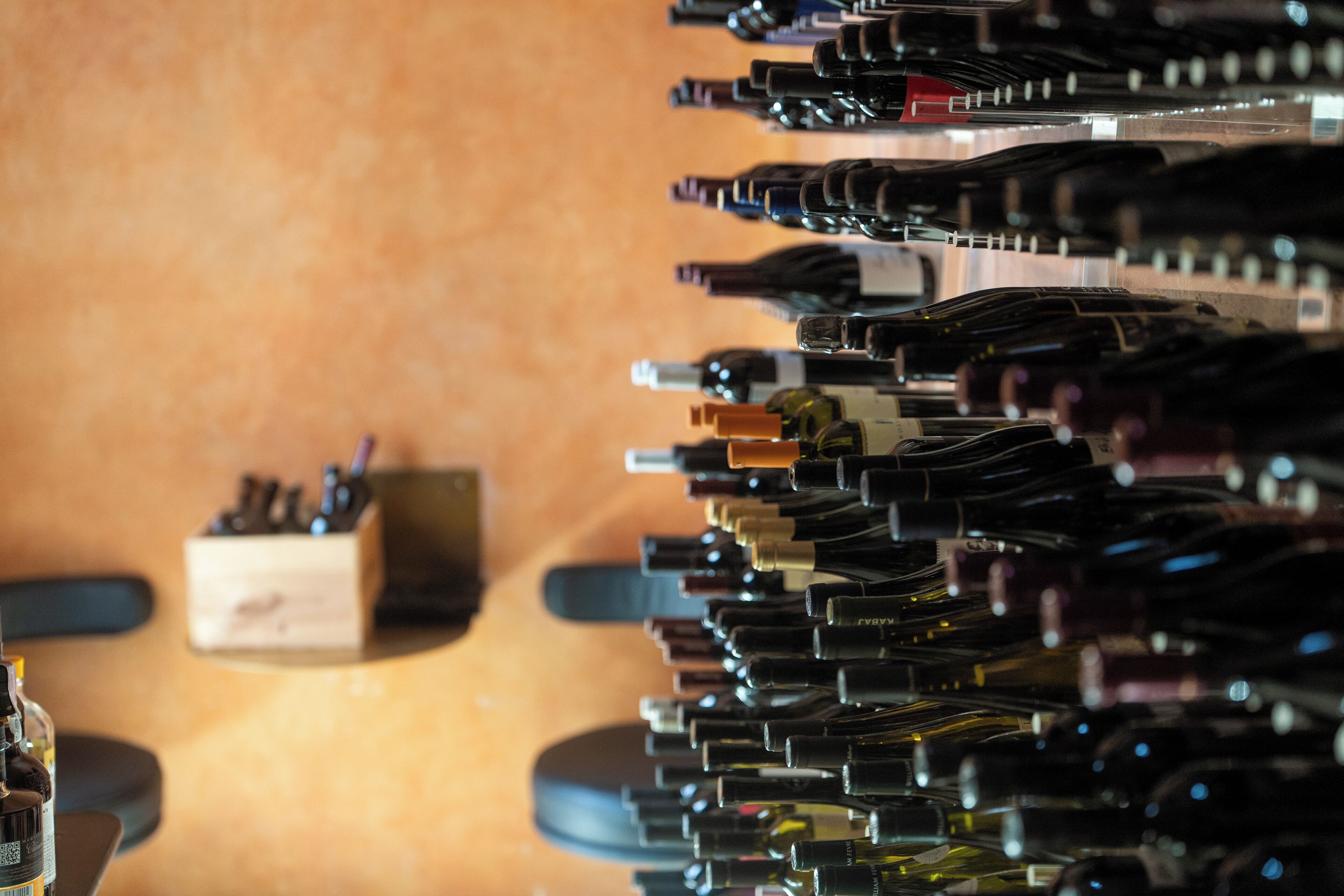A row of wine bottles on a shelf.