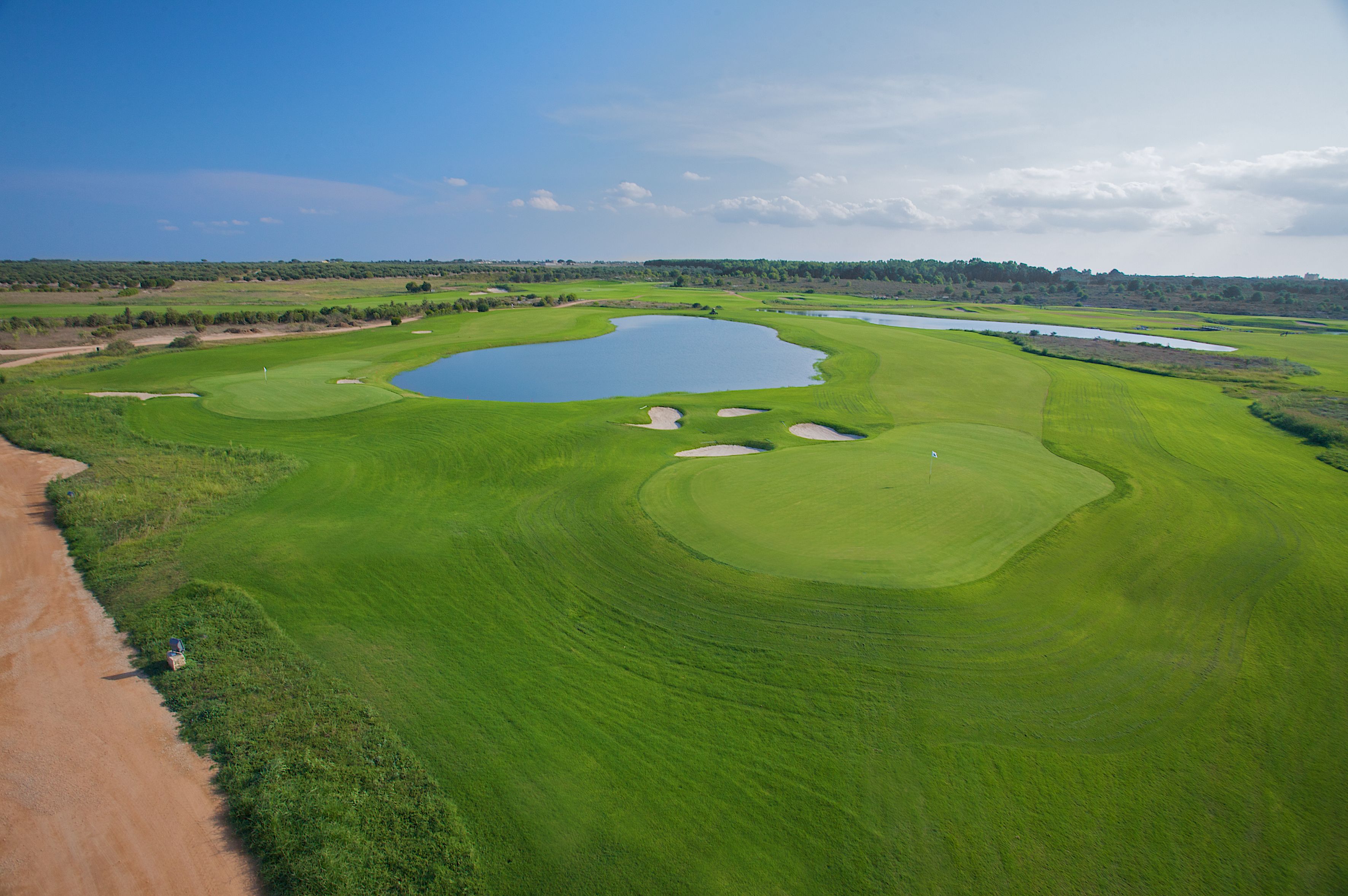 A golf course with multiple water hazards and sand bunkers.