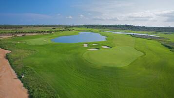 A golf course with multiple water hazards and sand bunkers.