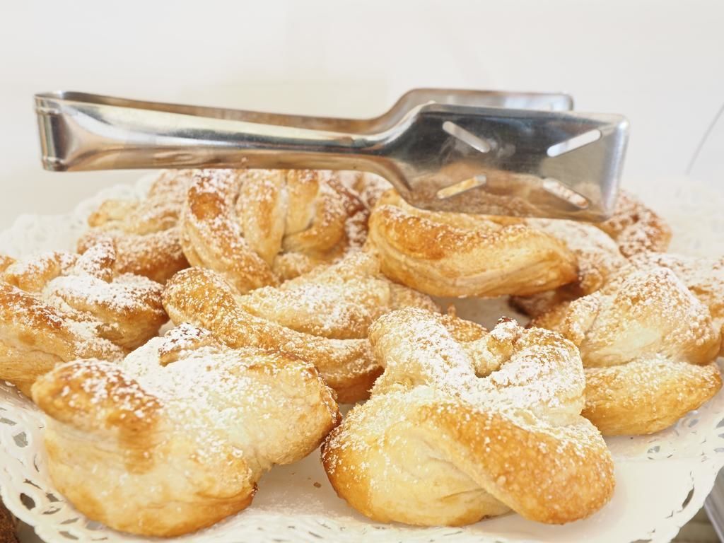 A tray of pastries dusted with powdered sugar.