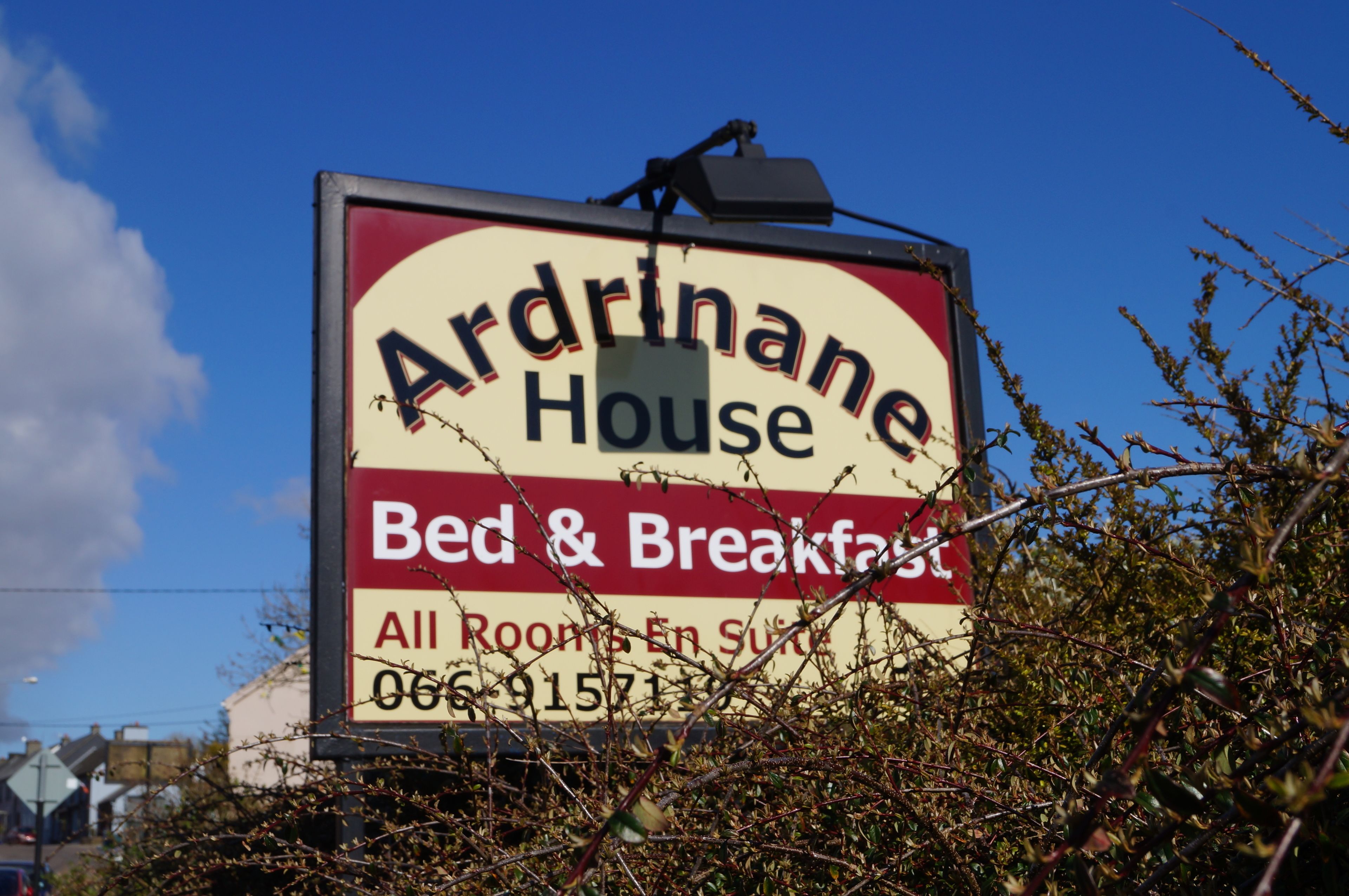 A sign for 'Aardrane House Bed & Breakfast' with a contact number.