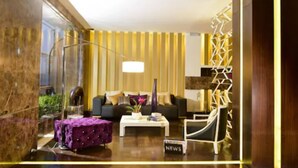 A modern living room with a sofa, coffee table, and decorative items.