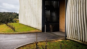 A modern building with a unique ribbed exterior wall and a large entrance. - Herdade da Rocha Boutique Lodge (Crato)
